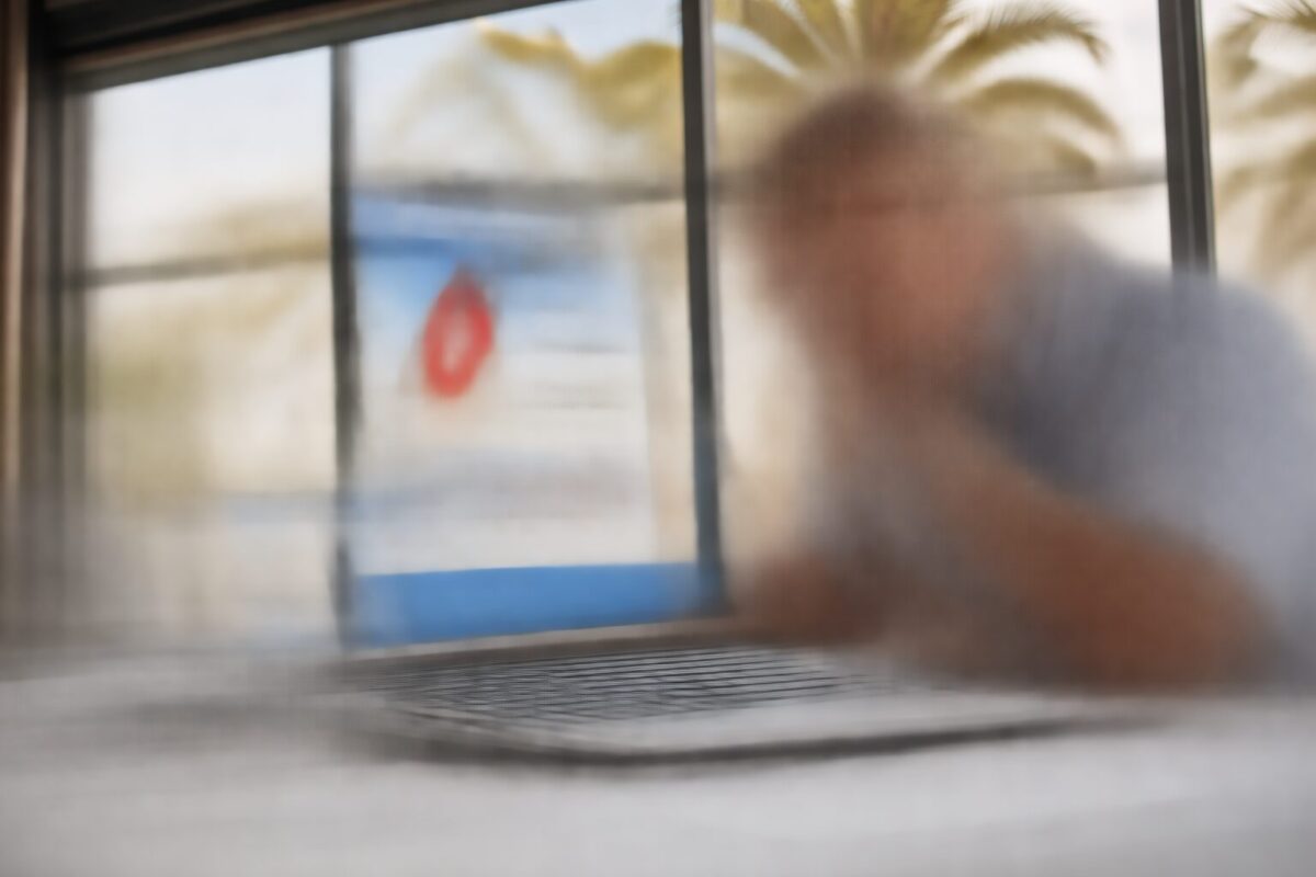 Business owner reviewing suspicious email on laptop in Fort Myers FL office